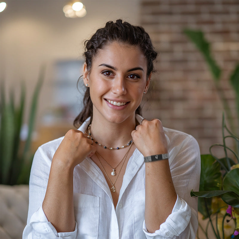 Confident woman in a white shirt smiling at camera